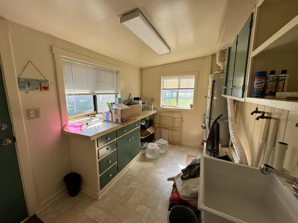 a bathroom with a tub sink and mirror