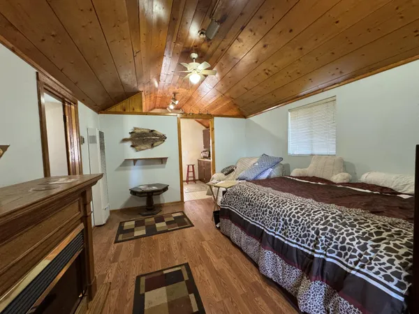 a bed room with a bed furniture and a chandelier