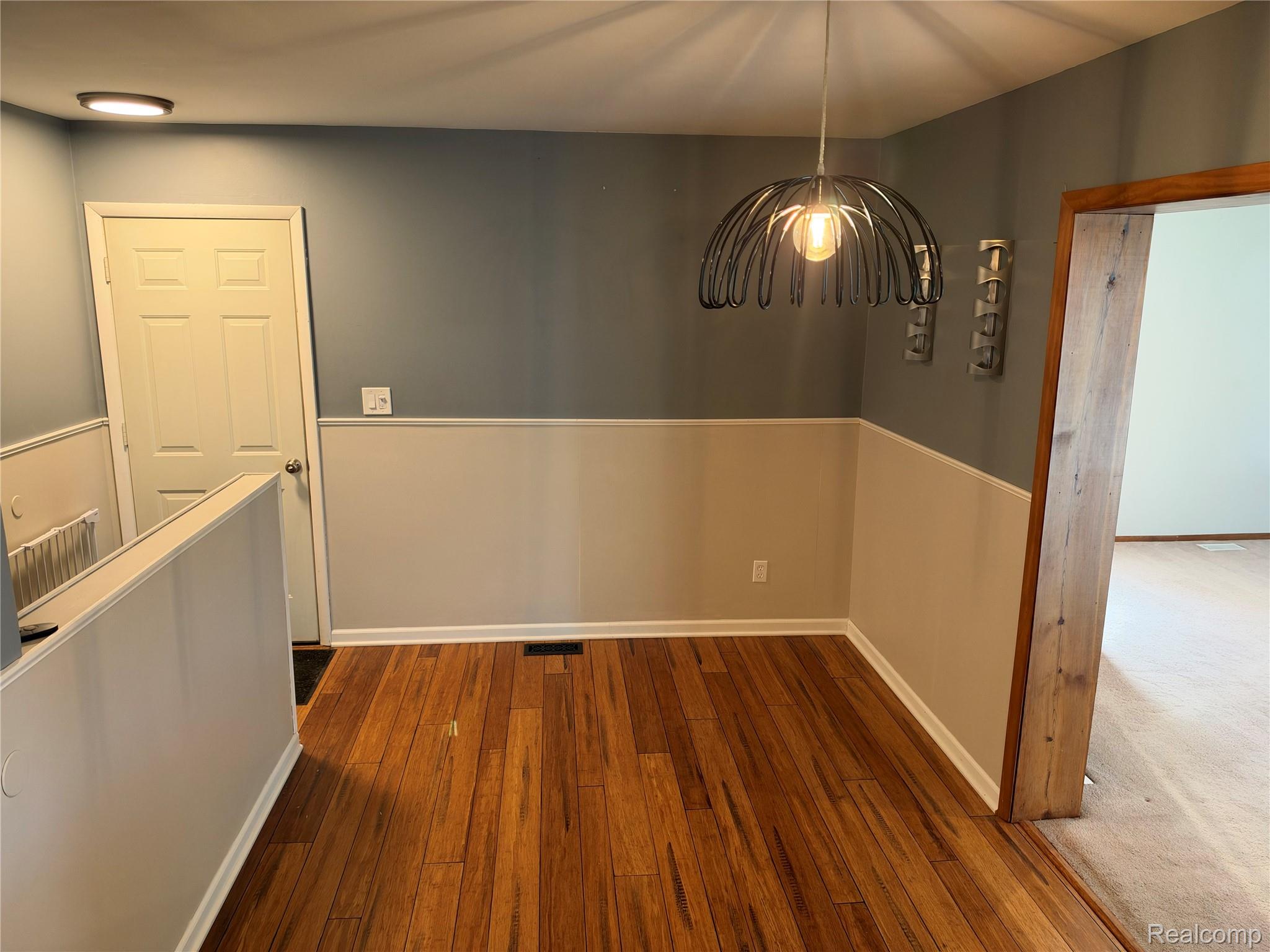 14629 Newburgh Road Livonia, MI 48154 - Photo 9 of 27 Hardwood flooring, two-tone wall treatment, decorative pendant light fixture, and recessed lighting