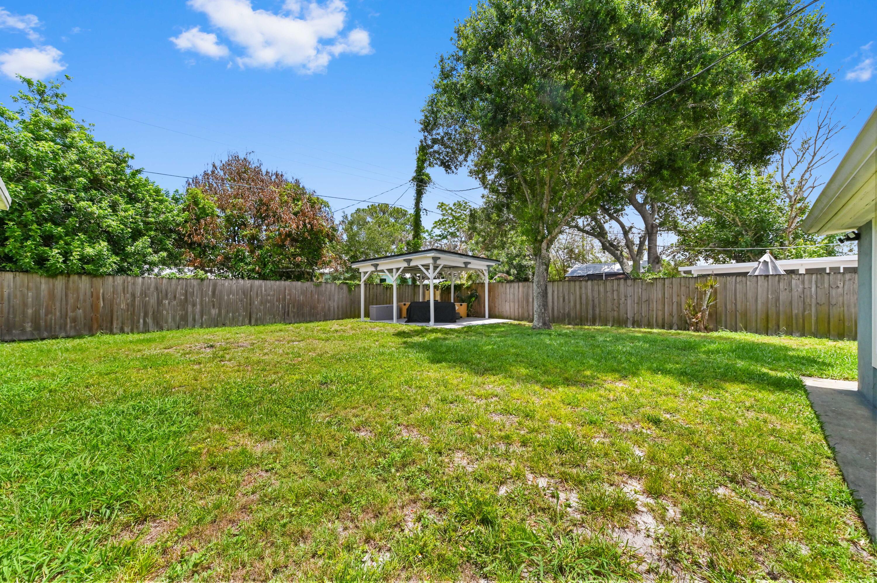 5709 Southeast Indigo Avenue Stuart, FL 34997 - Photo 26 of 26 a view of a house with a backyard