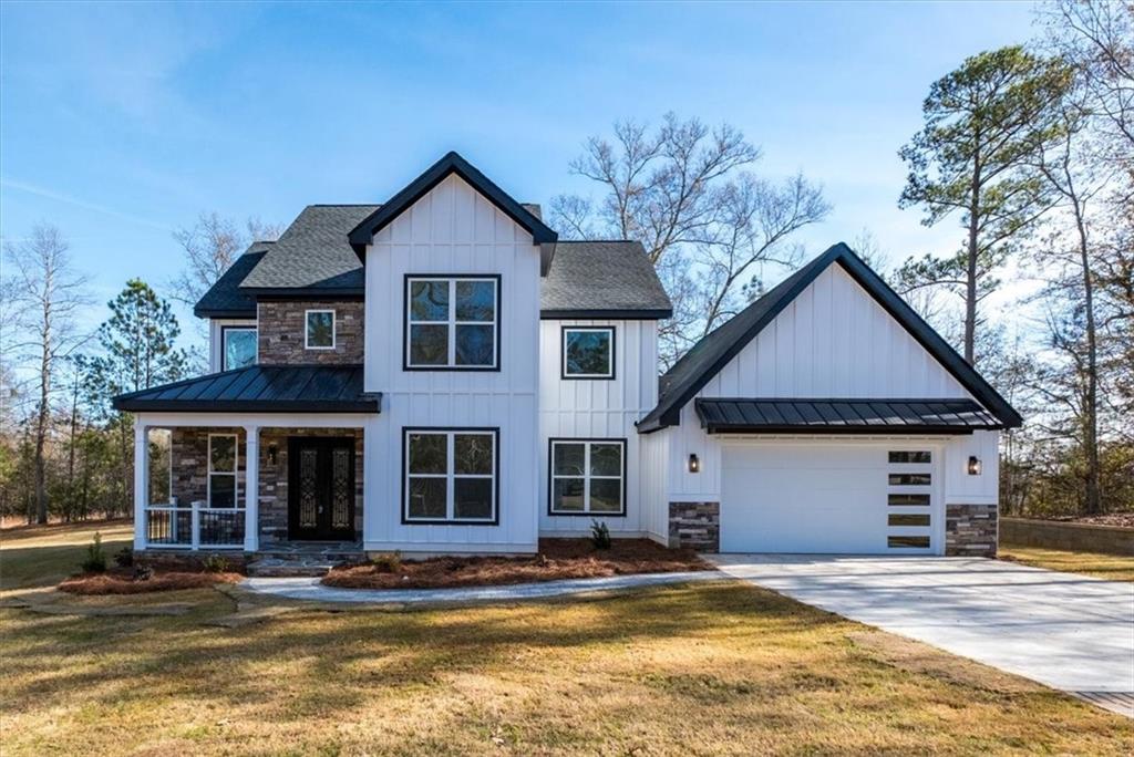 100 Lakeside Drive Forsyth, GA 31029 - Photo 1 of 1 a front view of a house with a yard and garage