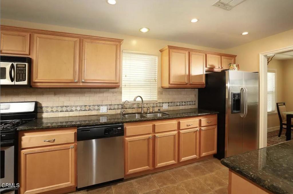 3226 La Crescenta Avenue Glendale, CA 91208 - Photo 17 of 18 a kitchen with stainless steel appliances granite countertop a refrigerator a sink a stove and cabinets