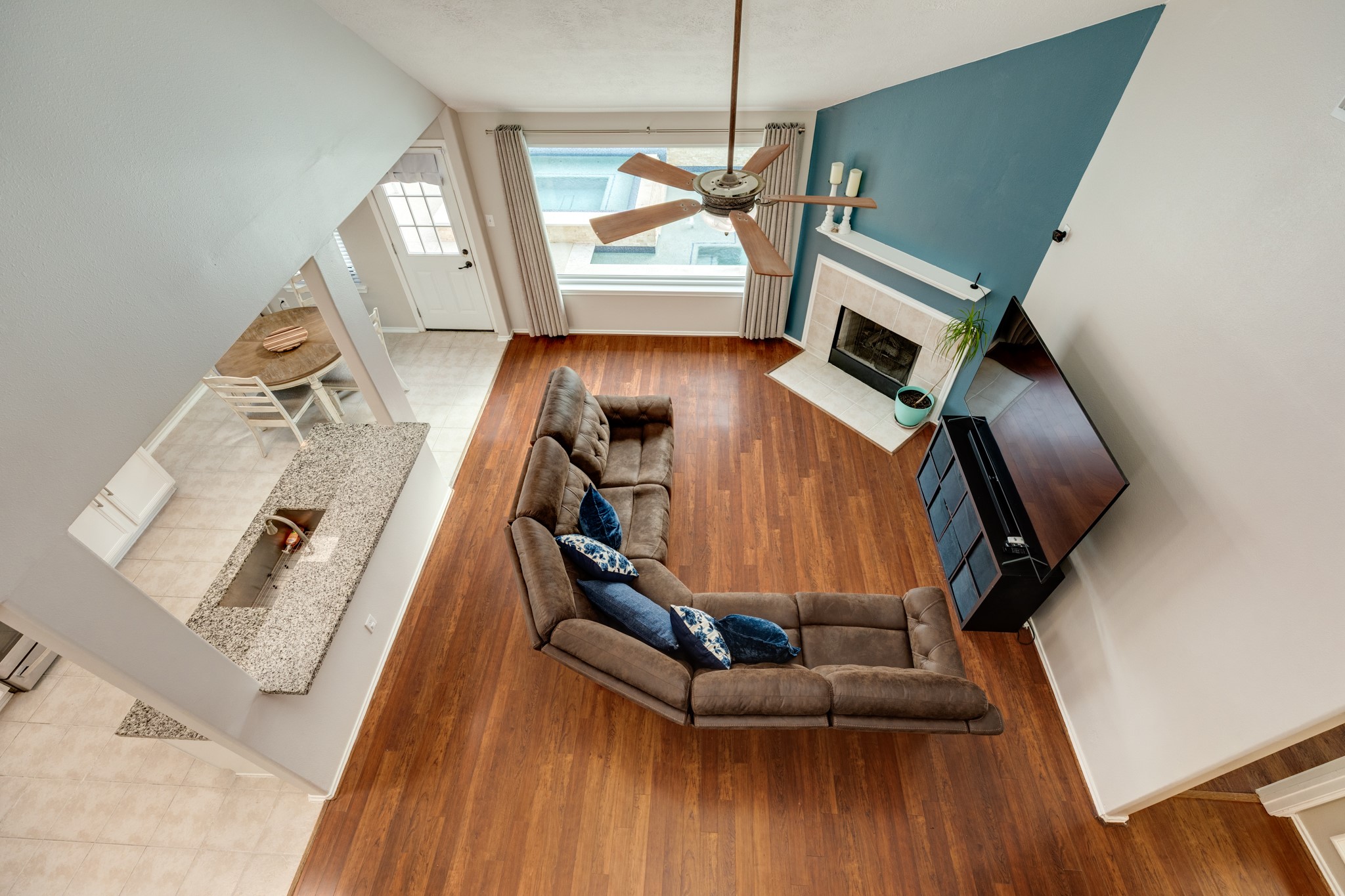 4113 Merlet Drive Pearland, TX 77584 - Photo 11 of 36 This photo showcases a view from the open ceiling located upstairs, highlighting the property's spacious and airy feel.