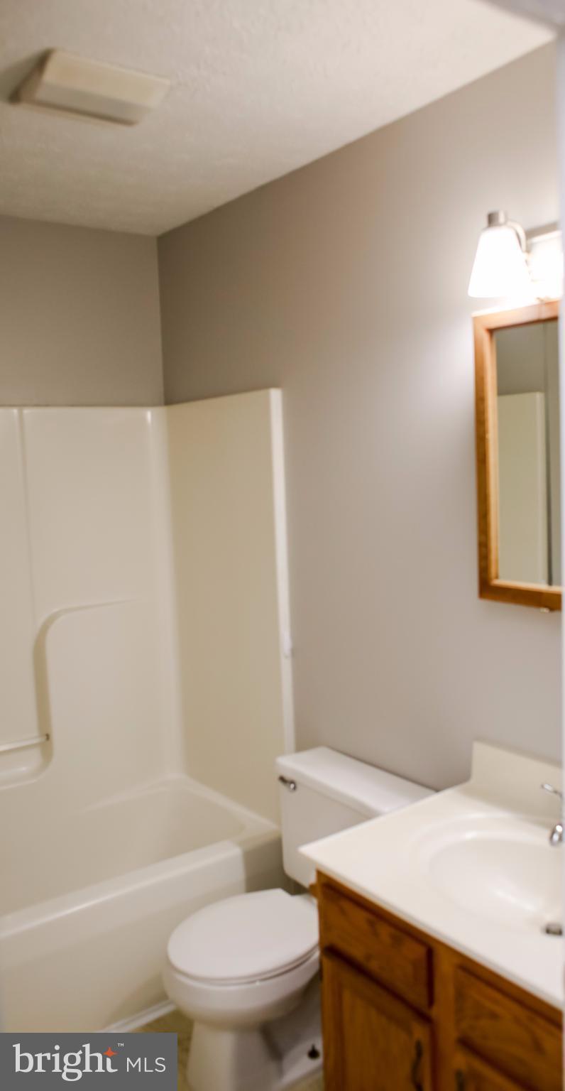 503 Burns Street Ranson, WV 25438 - Photo 9 of 15 a bathroom with a sink a toilet and shower