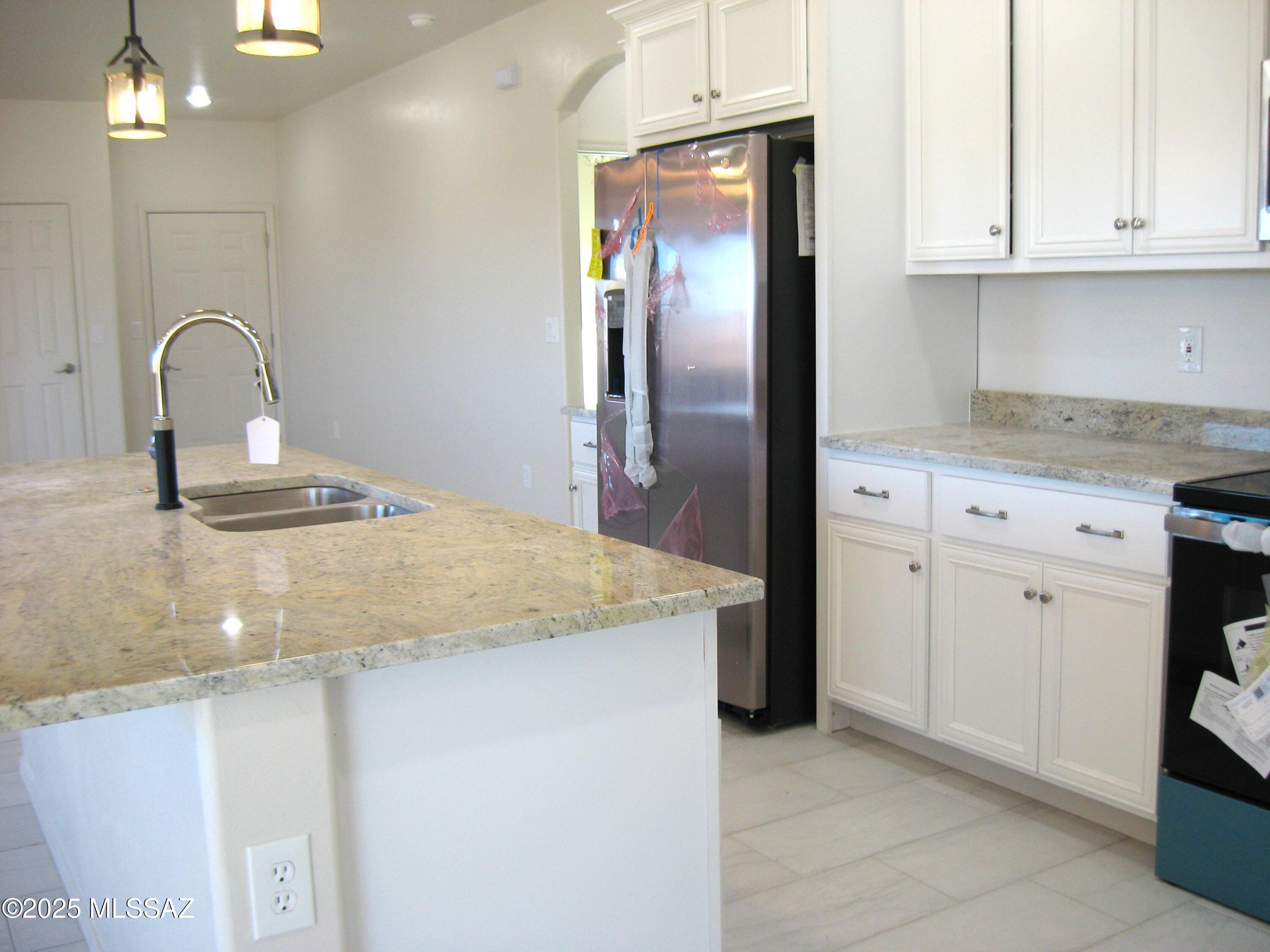 1734 Circulo Badajada Rio Rico, AZ 85648 - Photo 7 of 32 a kitchen with granite countertop a sink and refrigerator