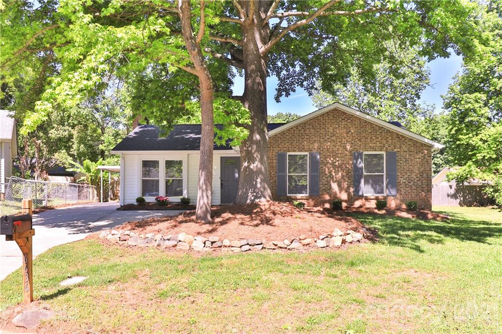 a front view of a house with yard and seating area