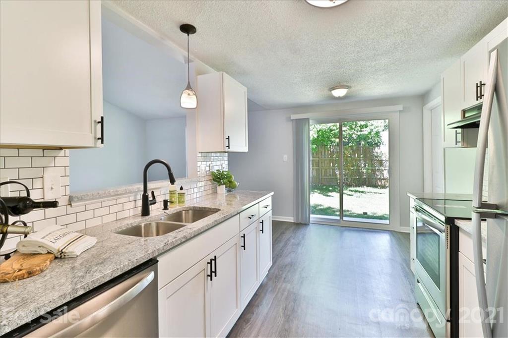 6636 Piney Path Road Charlotte, NC 28212 - Photo 13 of 24 a kitchen with sink cabinets and wooden floor