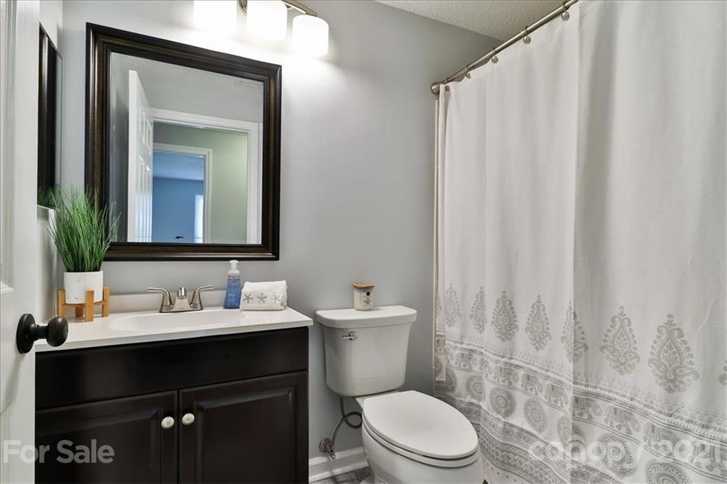 6636 Piney Path Road Charlotte, NC 28212 - Photo 16 of 24 a bathroom with a sink and a mirror