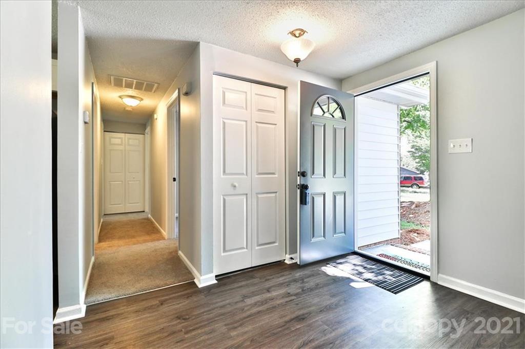 6636 Piney Path Road Charlotte, NC 28212 - Photo 4 of 24 a view of a hallway with wooden floor and windows