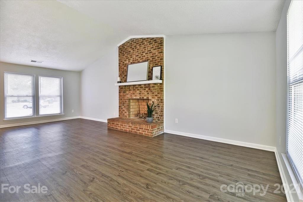 6636 Piney Path Road Charlotte, NC 28212 - Photo 6 of 24 an empty room with wooden floor cabinet and windows