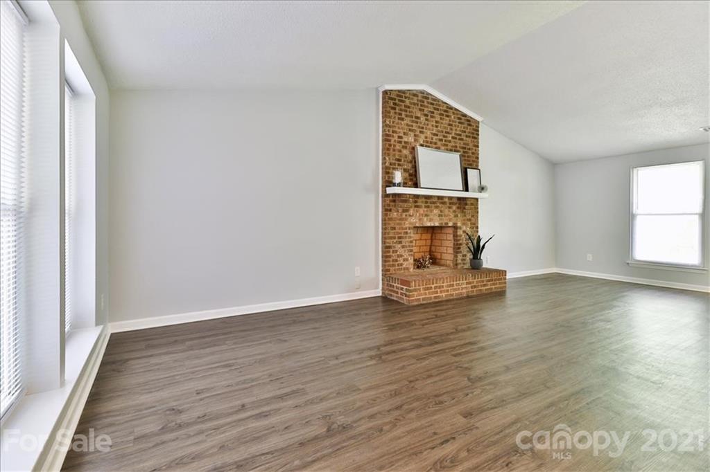6636 Piney Path Road Charlotte, NC 28212 - Photo 7 of 24 an empty room with wooden floor cabinet and windows