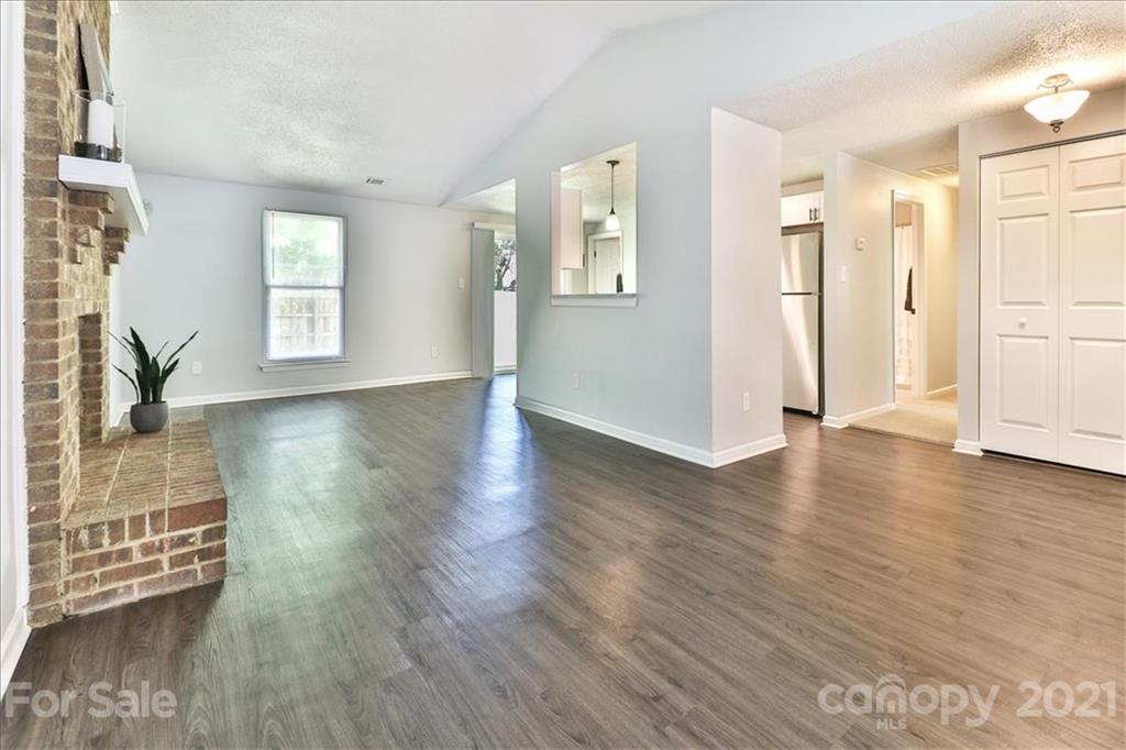 6636 Piney Path Road Charlotte, NC 28212 - Photo 9 of 24 a view of empty room with wooden floor and window