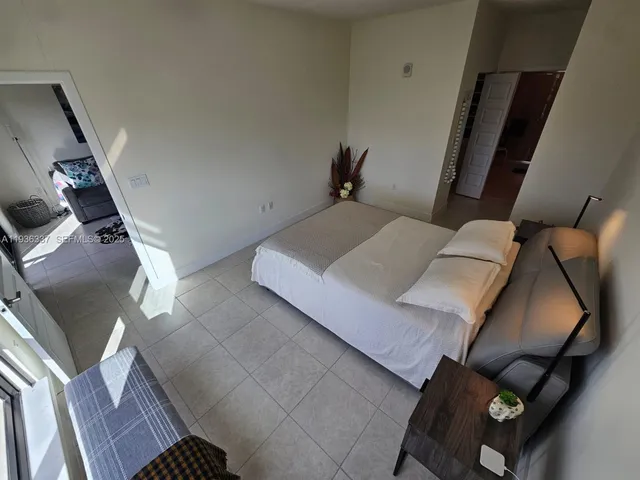 a bedroom with a bed and a mirror