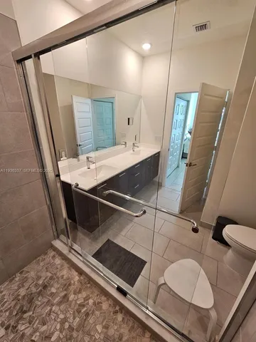 a bathroom with a sink a mirror and a shower