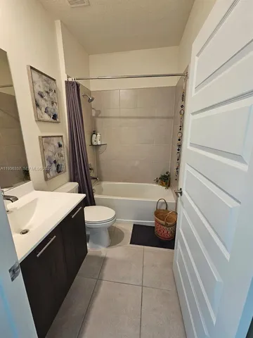 a spacious bedroom with a bed and a window