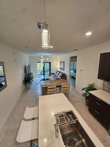 a kitchen with a refrigerator and a stove