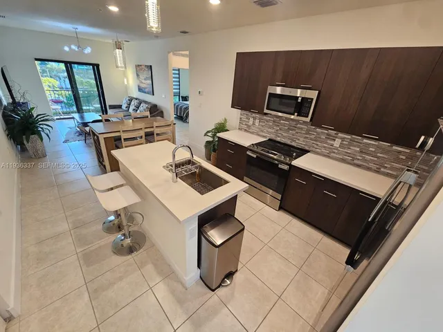 a kitchen with a sink appliances and cabinets