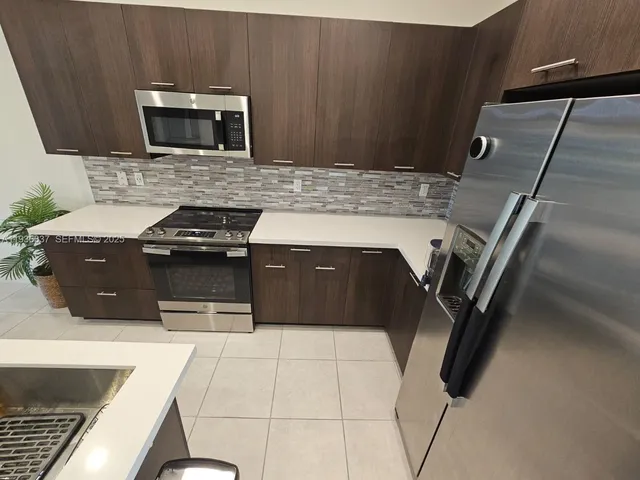 a kitchen with a stove microwave and sink