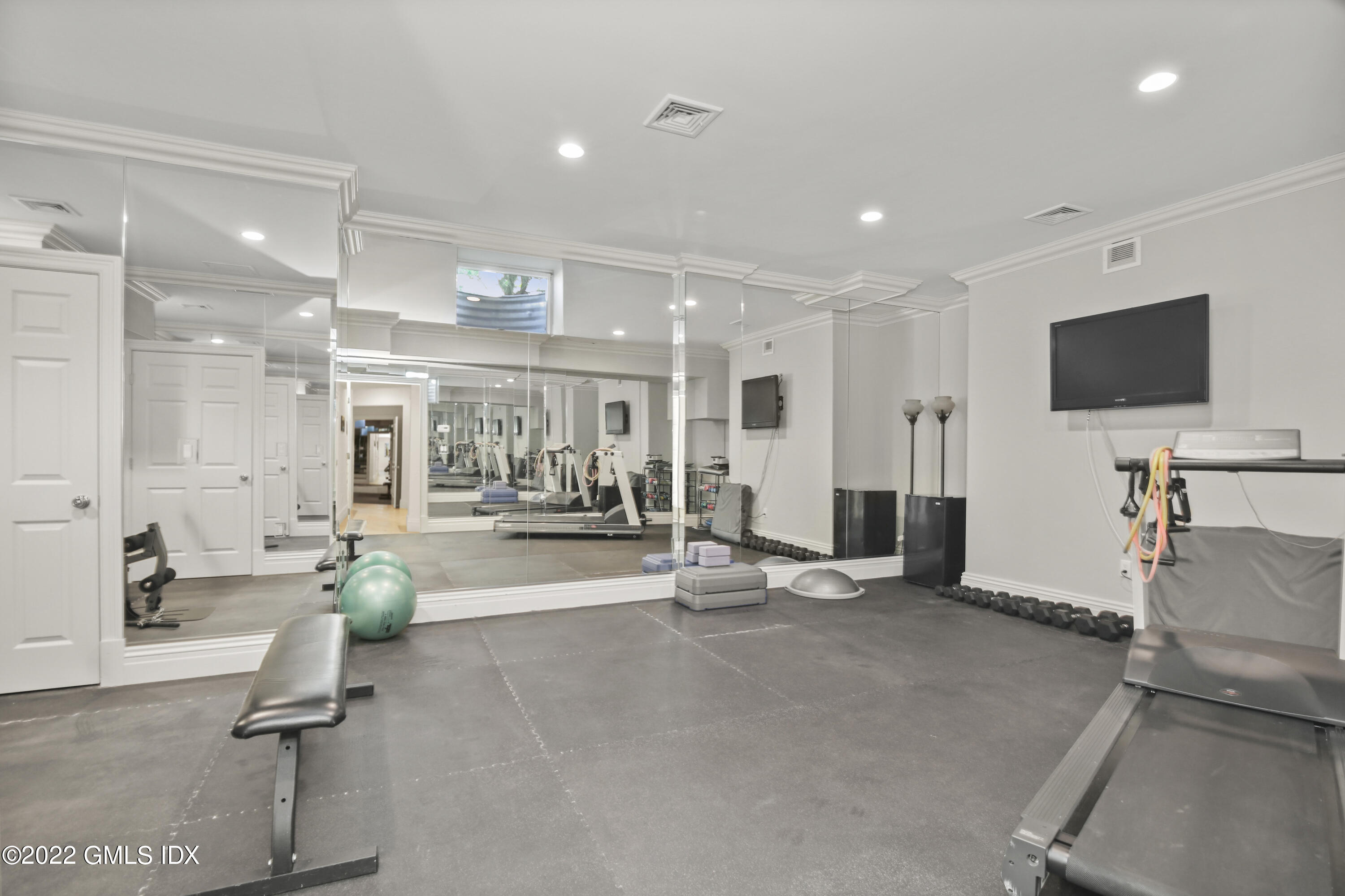 13 Chieftans Road Greenwich, CT 06831 - Photo 54 of 67 a room with gym equipment and a large window