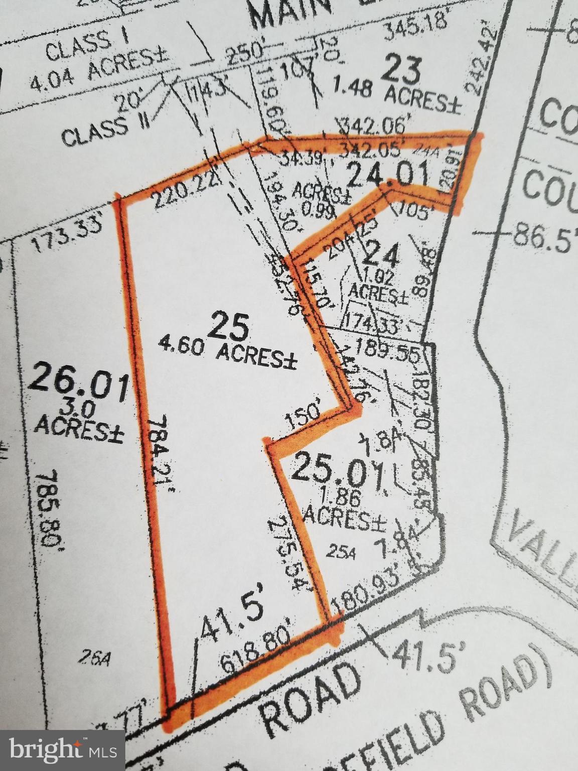 view of a bed with a white comforter