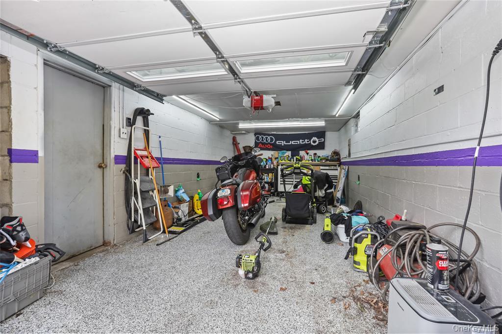 36 Edgewood Road Cortlandt Manor, NY 10567 - Photo 19 of 22 Spacious 1-car garage with epoxy-style flooring, offering ample storage and workspace potential