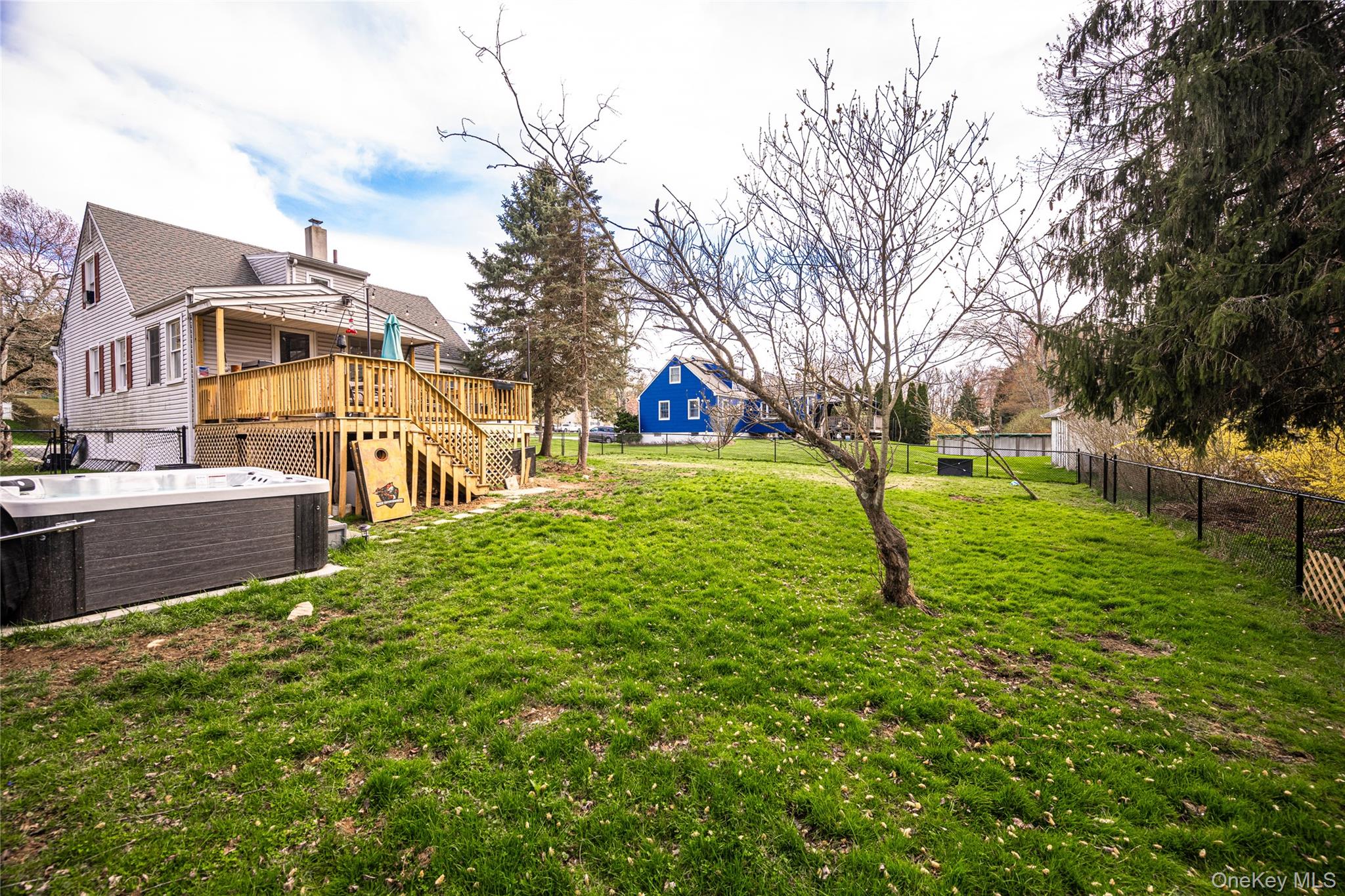 36 Edgewood Road Cortlandt Manor, NY 10567 - Photo 20 of 22 Spacious, level backyard offering plenty of room for outdoor activities, entertaining, or future enhancements, complete with an elevated deck overlooking the property.