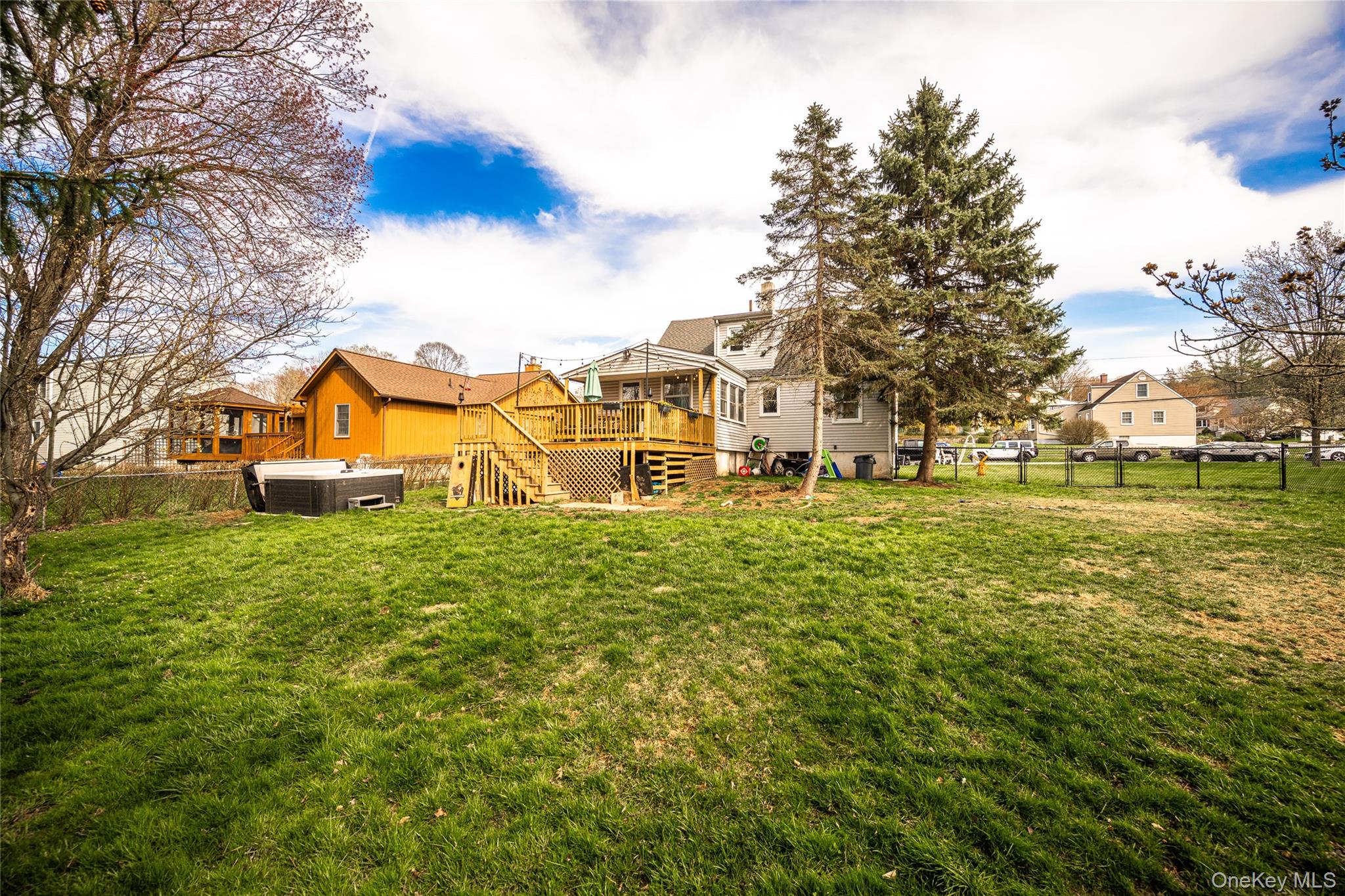 36 Edgewood Road Cortlandt Manor, NY 10567 - Photo 21 of 22 Spacious, level backyard offering plenty of room for outdoor activities, entertaining, or future enhancements, complete with an elevated deck overlooking the property.