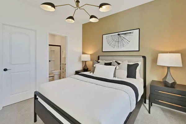 a bedroom with bed and wooden floor