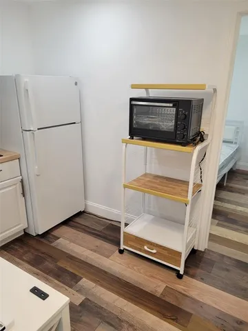 a bedroom with a bed and a wall painting