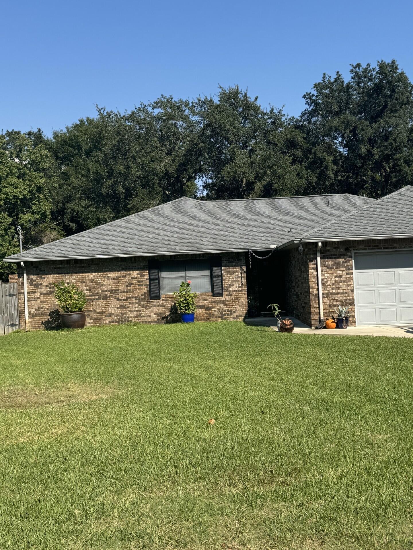 a view of a house with a backyard
