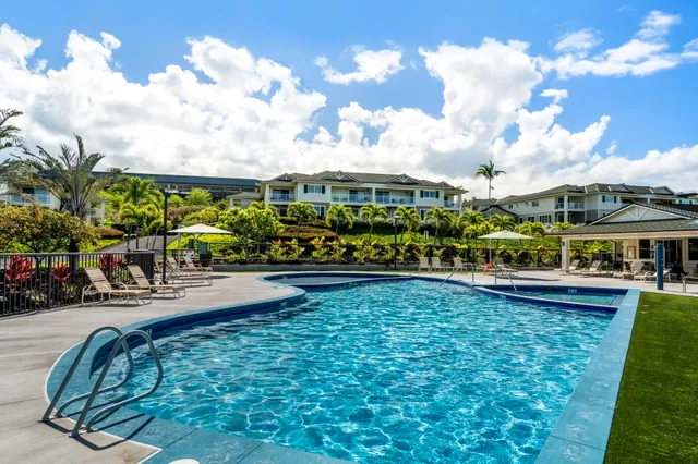 a view of swimming pool with outdoor seating and a garden