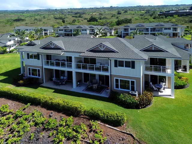a view of a house with a big yard plants and large trees