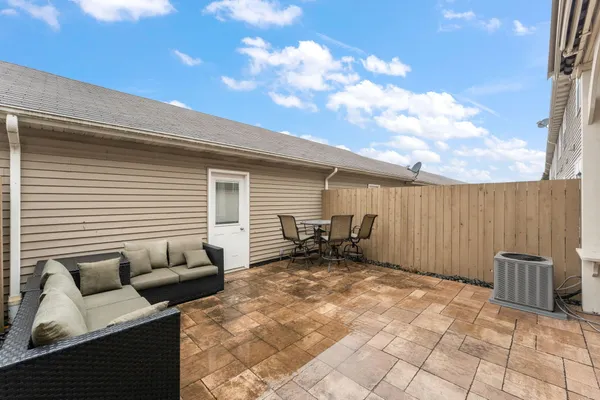 a backyard of a house with table and chairs