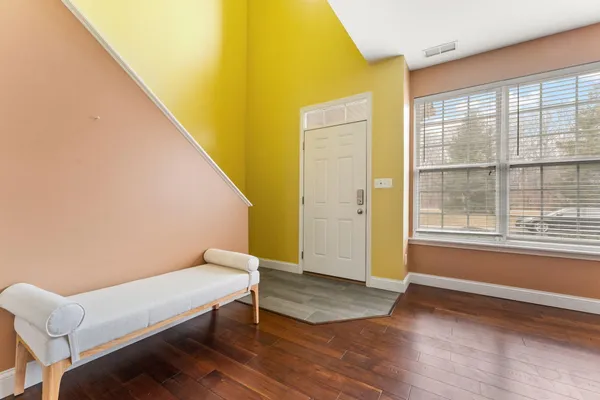 a view of a room with wooden floor and a window