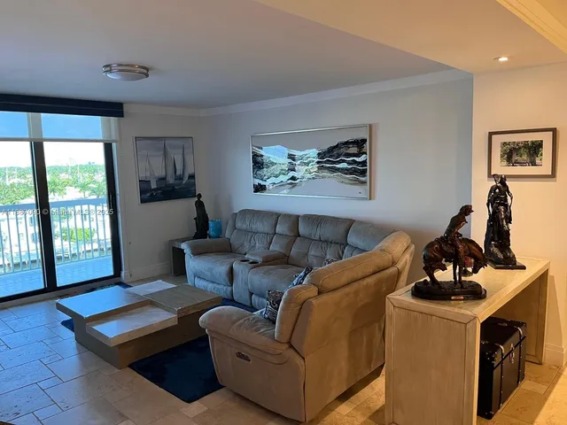 a bedroom with furniture and a large window