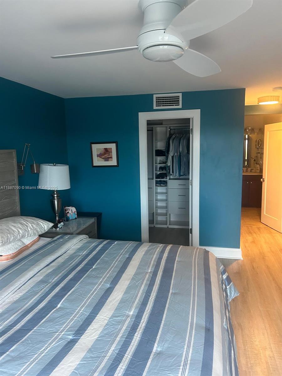 1500 South Ocean Drive, Unit A8 Hollywood, FL 33019 - Photo 27 of 53 a bedroom with a large bed and a chandelier