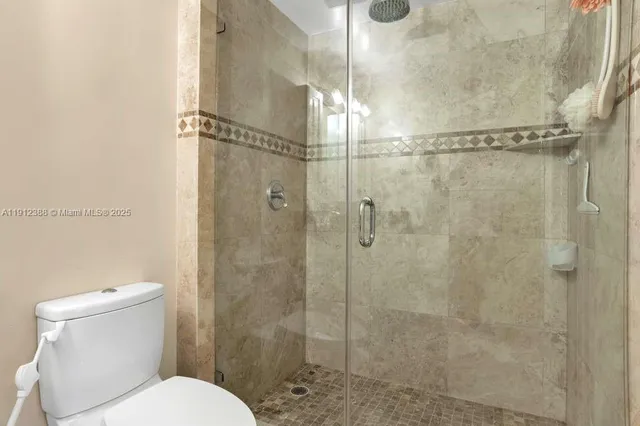 a bathroom with a toilet and shower