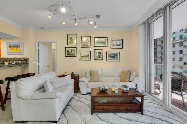 a living room with furniture and large window