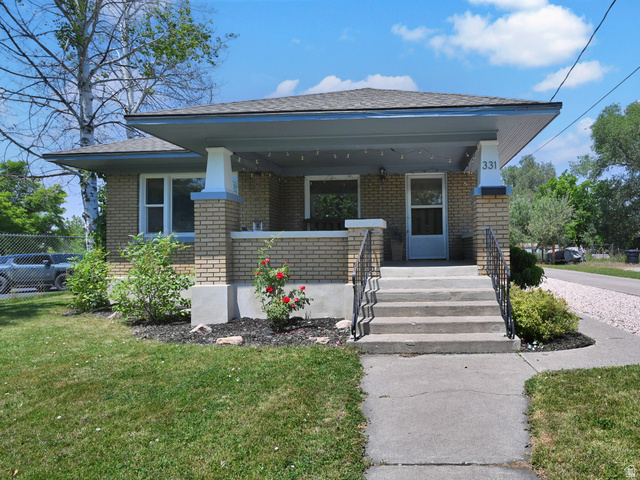 331 West 300 North Logan, UT 84321 - Photo 20 of 28 Brick exterior featuring a covered porch