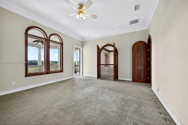 a view of a porch with wooden floor and iron gate