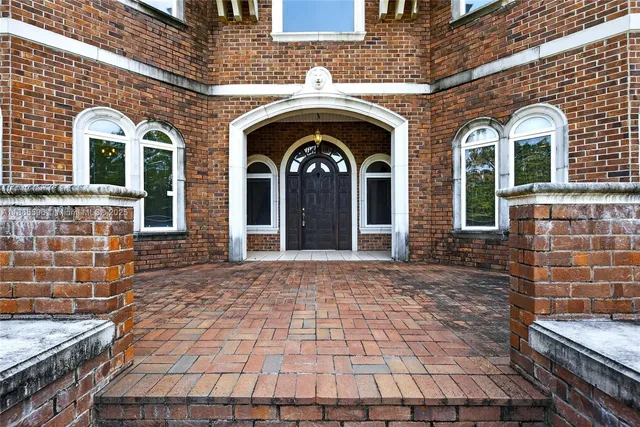 a living room with stainless steel appliances kitchen island granite countertop a stove top oven a sink and a refrigerator