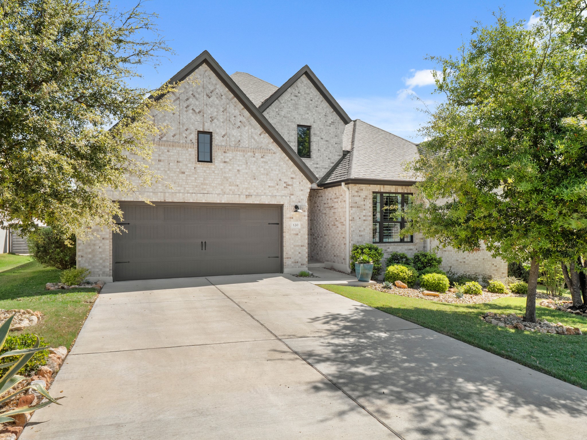 a front view of a house with a yard and garage