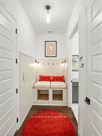 a view of a bedroom with a bed and white walls