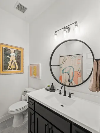 a bathroom with a toilet a sink and a mirror