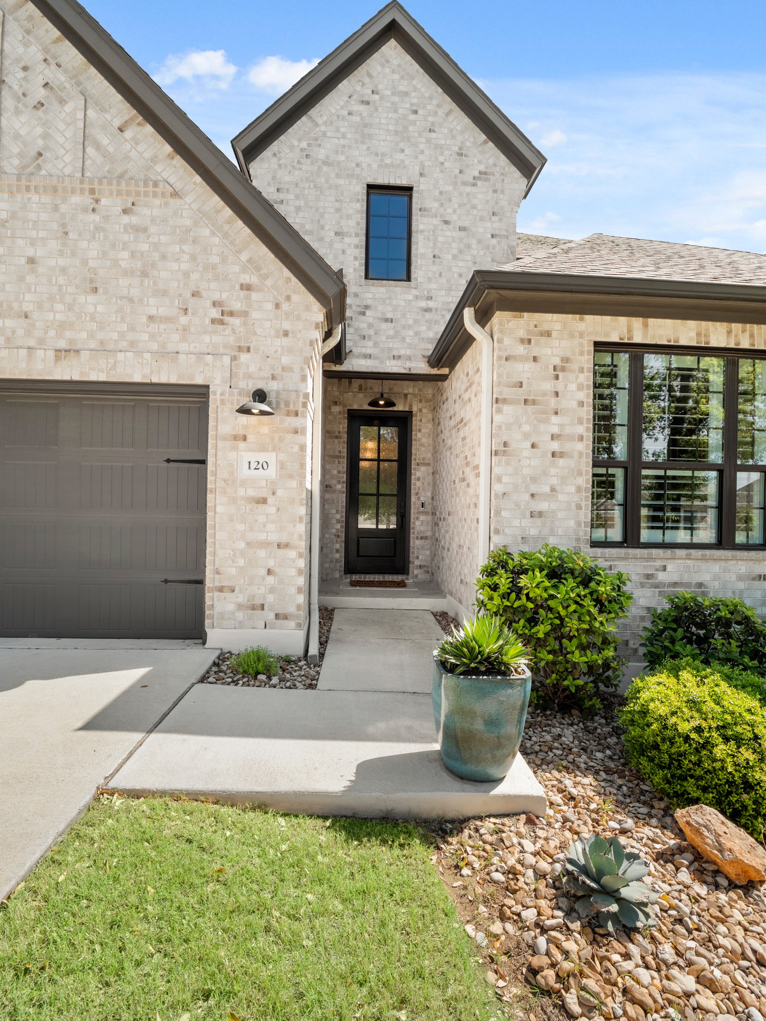 120 Eagle Pass Trail Georgetown, TX 78628 - Photo 2 of 32 a front view of a house with a yard and potted plants
