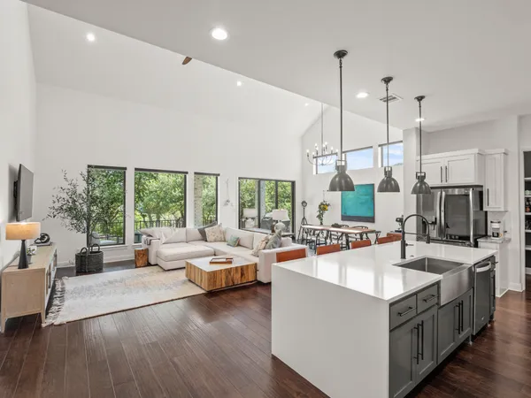 a large room with kitchen island a large window in it