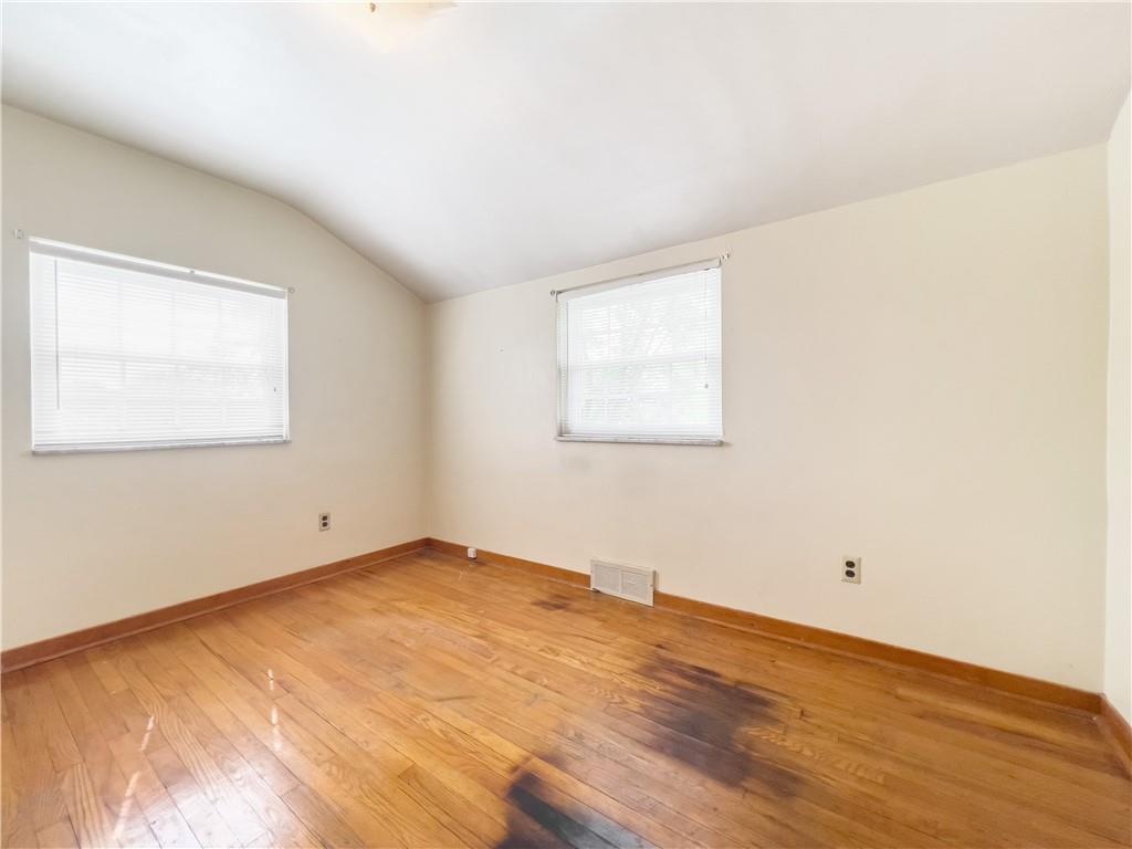 2023 Spring Hill Road Pittsburgh, PA 15243 - Photo 18 of 20 an empty room with wooden floor and windows