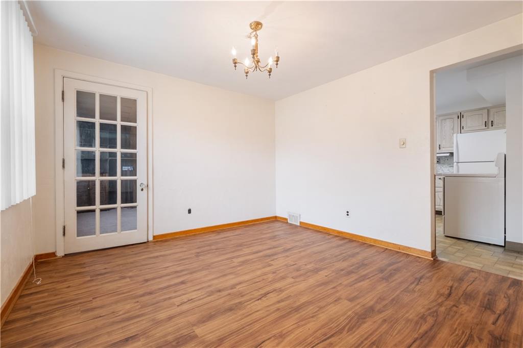 2023 Spring Hill Road Pittsburgh, PA 15243 - Photo 5 of 20 an empty room with wooden floor and a window