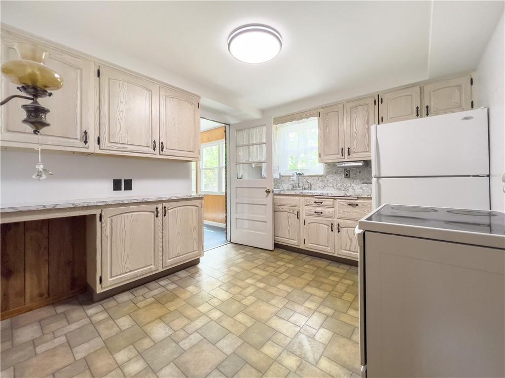 2023 Spring Hill Road Pittsburgh, PA 15243 - Photo 6 of 20 a kitchen with white cabinets and white appliances