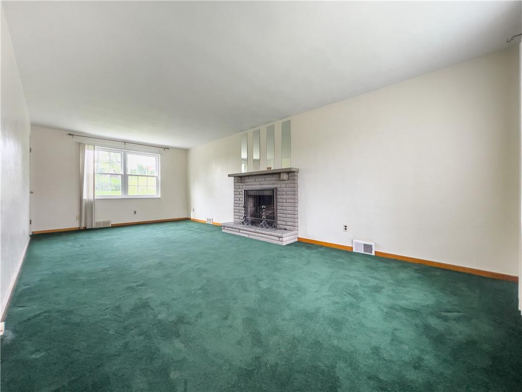 2023 Spring Hill Road Pittsburgh, PA 15243 - Photo 9 of 20 an empty room with fireplace and window
